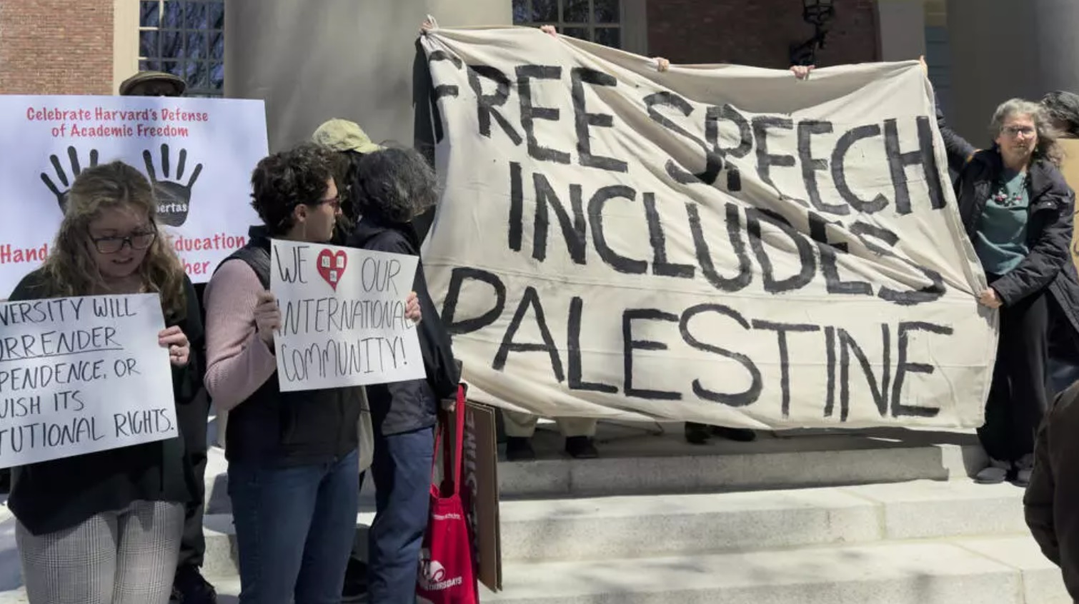 Students, faculty and members of the Harvard University community rally